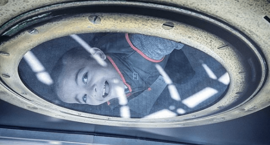 visitor interacting with porthole design